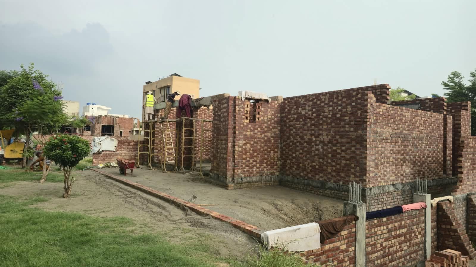 Brick wall and plinth beam taking shape at a residential construction site in Lahore