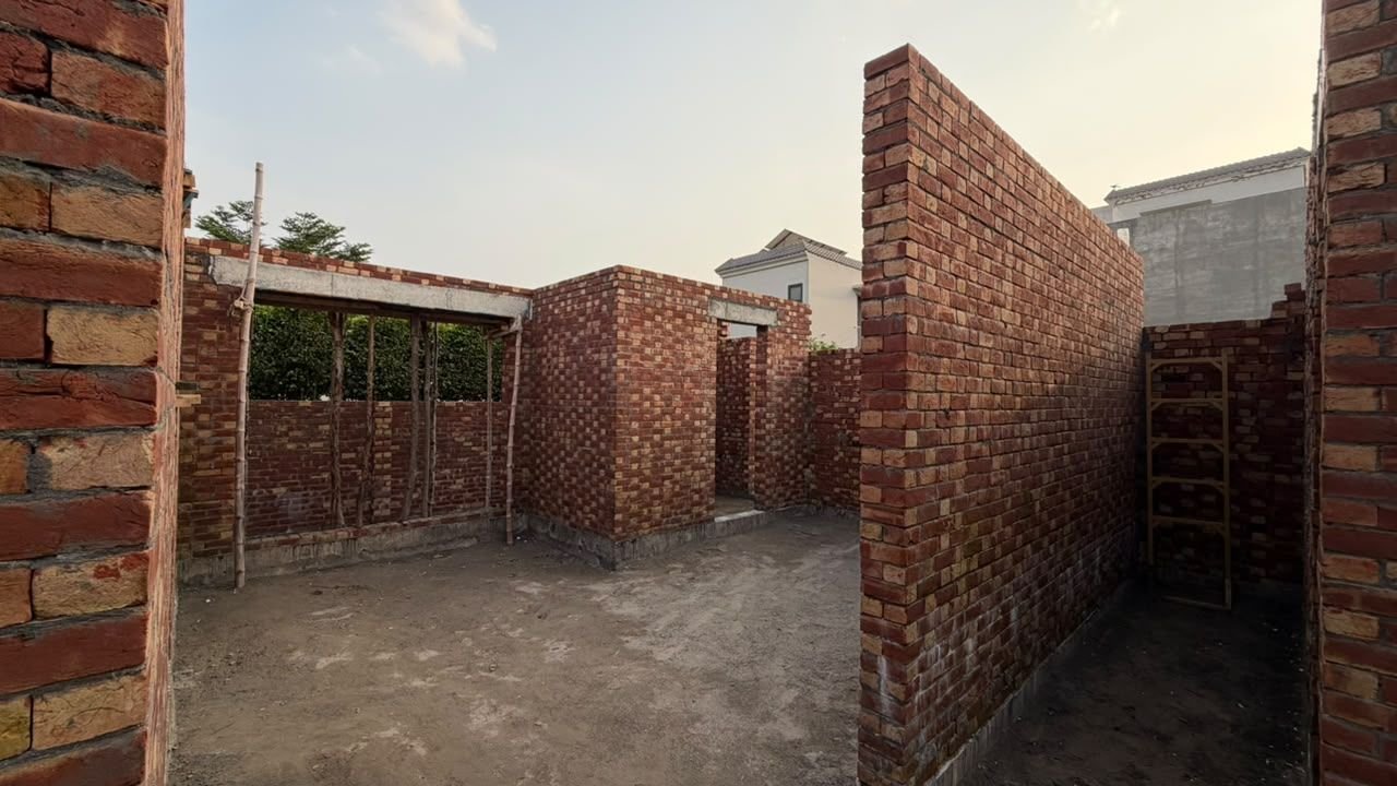 Brick walls and room openings on a house under construction in Lake City Lahore